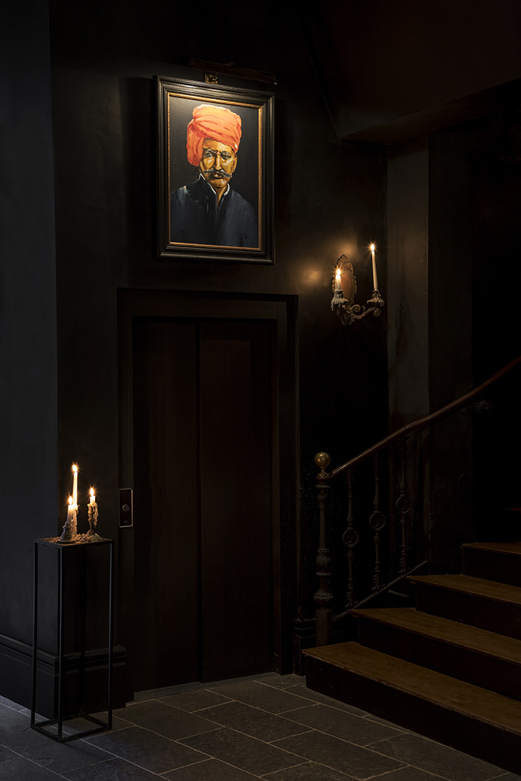 Pablo Peyra diseño del Hotel Palma Riad. Escalera de madera junto a ascensor, con retrato enmarcado y velas encendidas. Pablo Peyra diseño del Hotel Palma Riad. Escalera de madera junto a ascensor, con retrato enmarcado y velas encendidas.